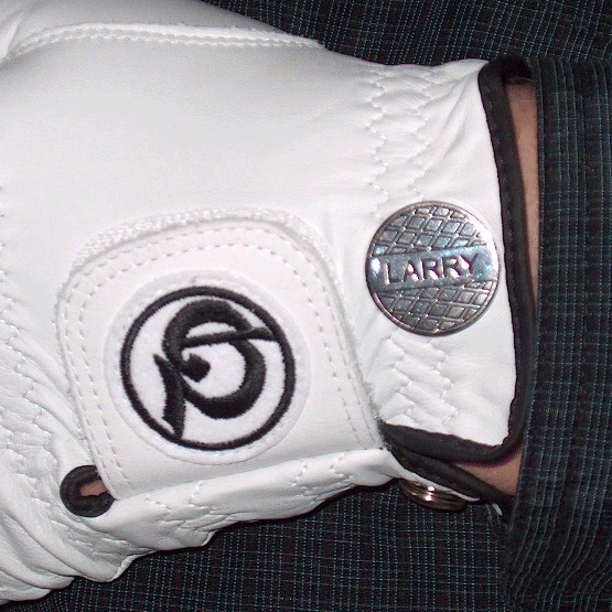 Magnetic marker held onto the outside cuff of a golf glove